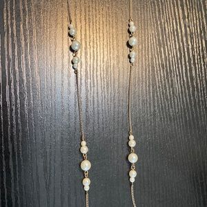 Very long faux pearl necklace